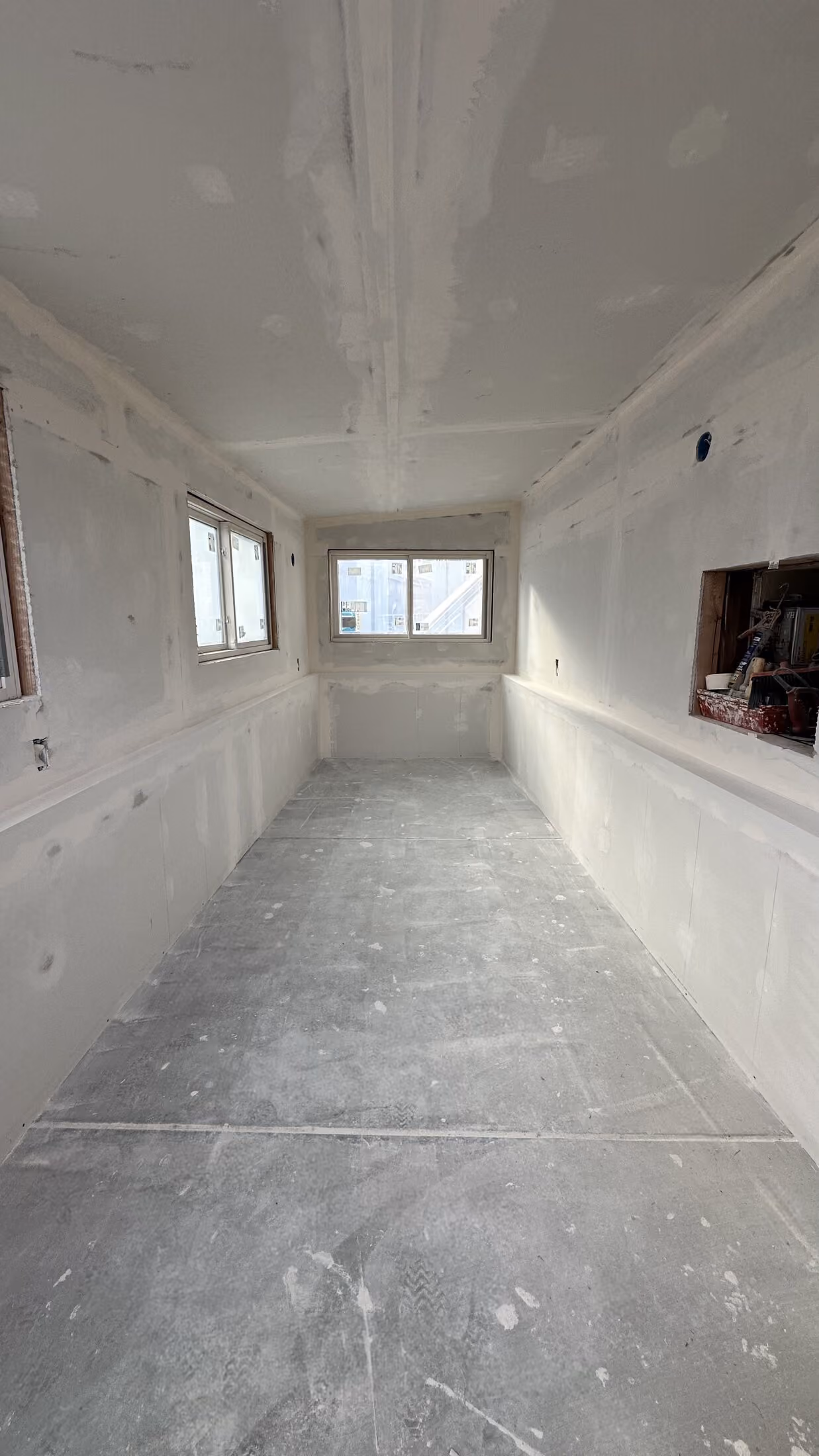 Drywall and window openings inside the addition