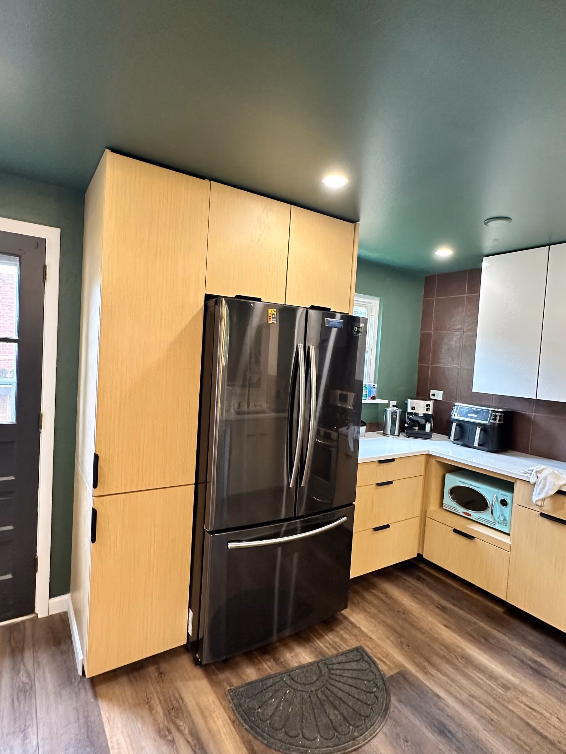 Refrigerator surround and fitted cabinetry in the Pleasant Valley kitchen