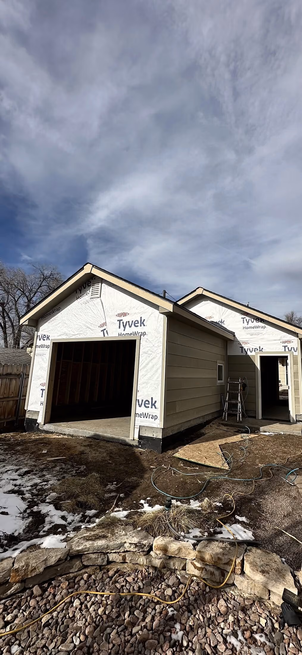 Detached garage enclosed with roof and weather barrier