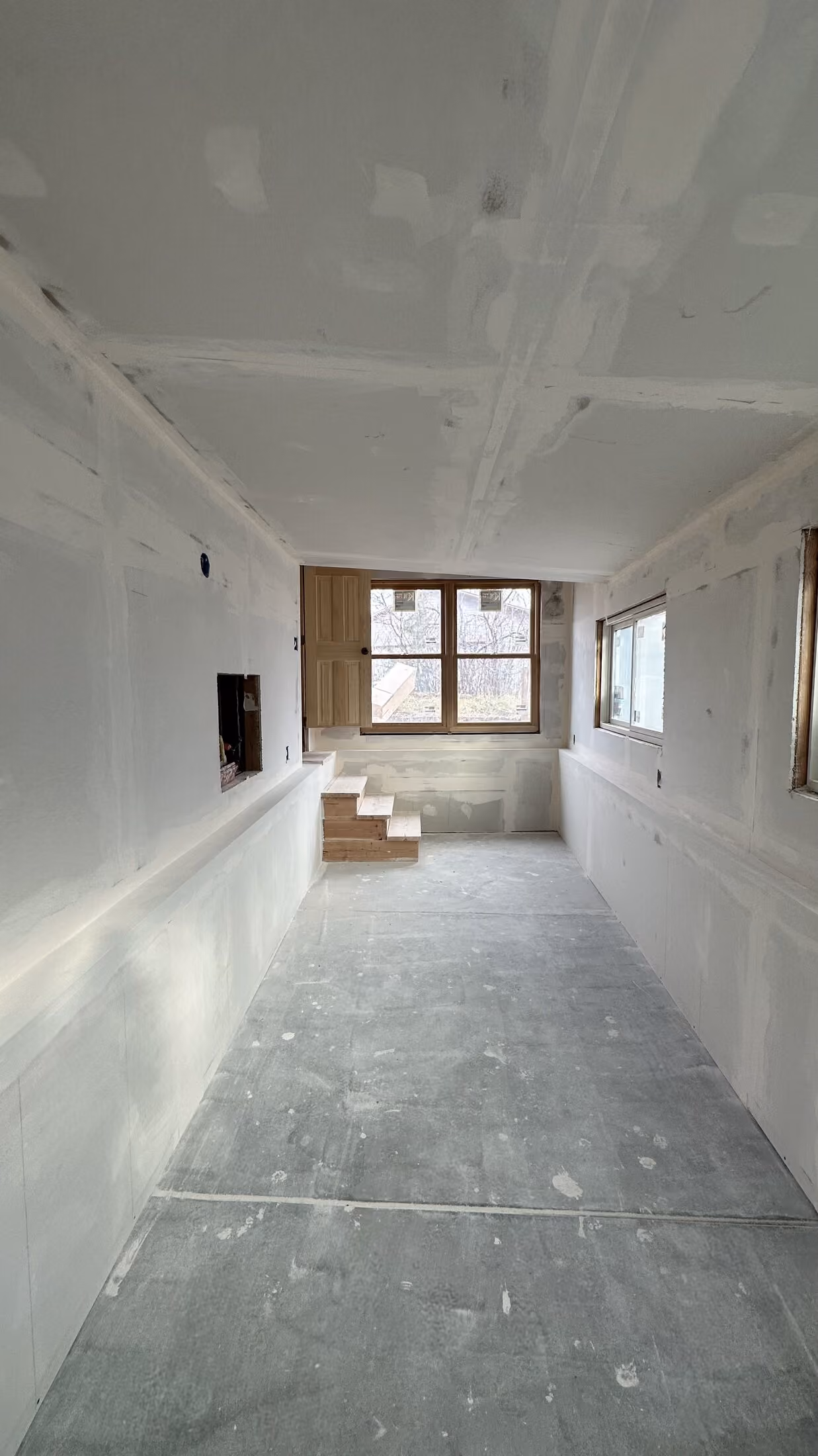 Long interior of the addition after drywall installation