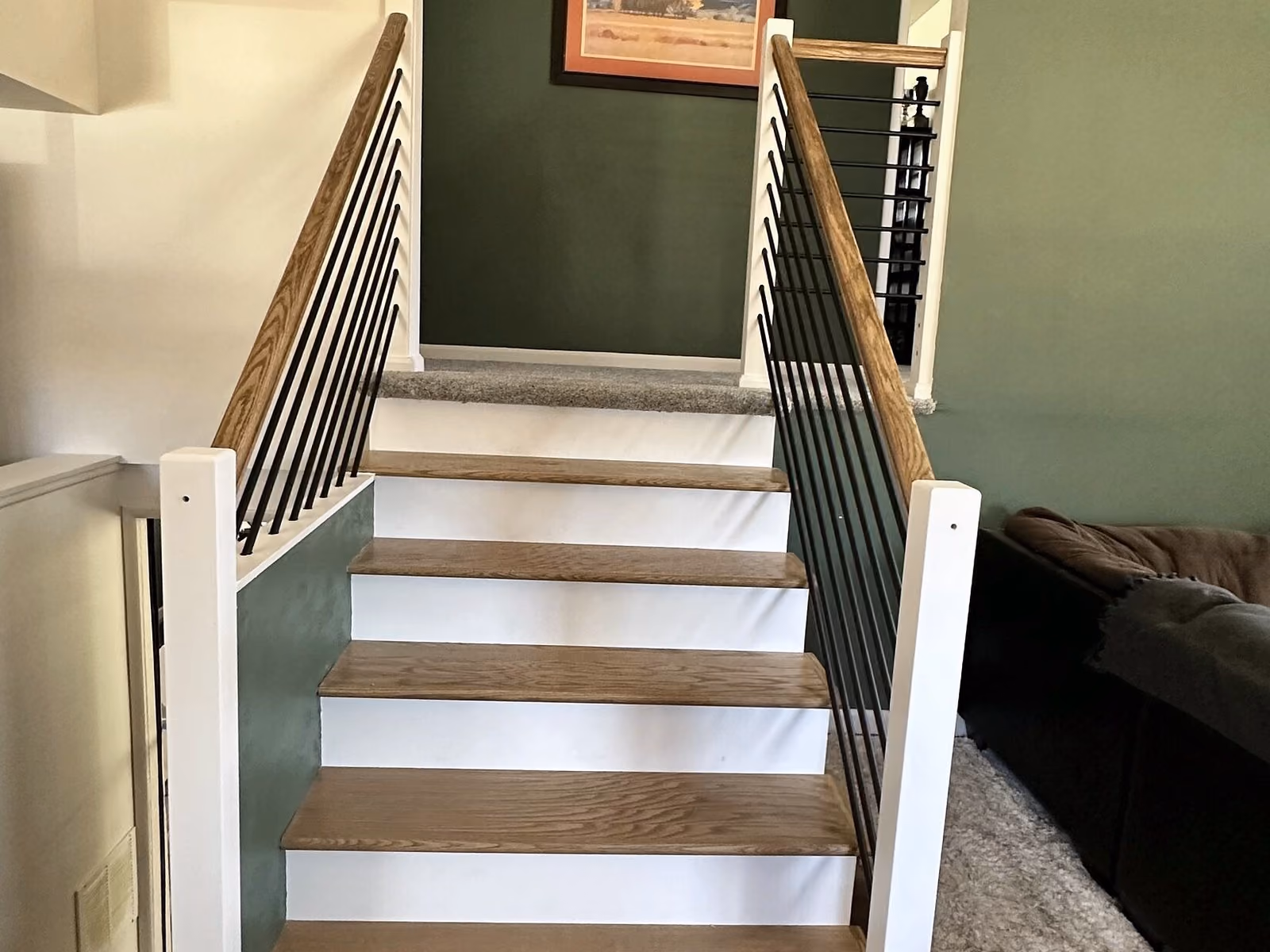 Finished custom stair treads and railing from the lower landing