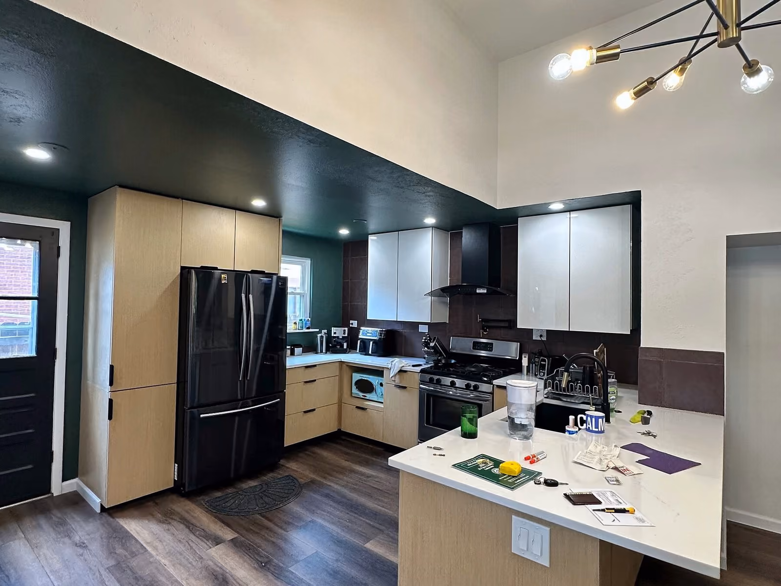 Wide view of the renovated Pleasant Valley kitchen with new cabinets, counters, and backsplash